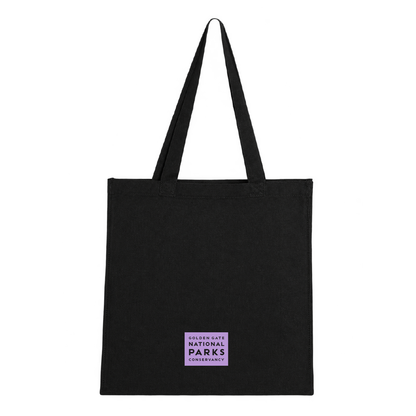 Black tote bag with purple Alcatraz Island design and screenprint, back side with logo, limited edition by the Golden Gate National Parks Conservancy.