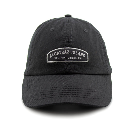 Black baseball cap with embroidered Alcatraz Island label on front panels.