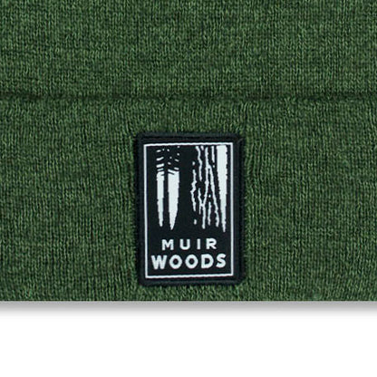Muir Woods logo on a green knit cap background