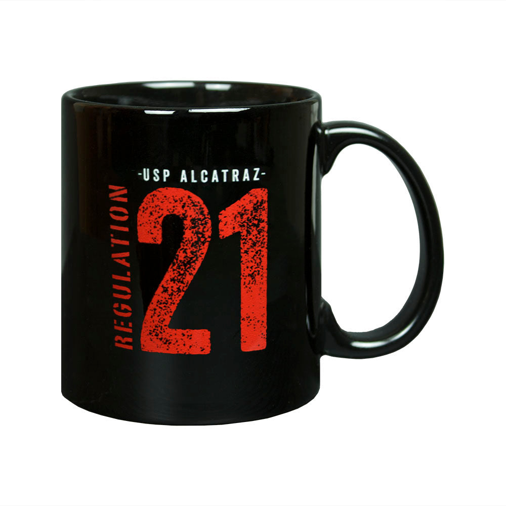 Black mug with red and white Alcatraz Regulation 21 text You are required to work...