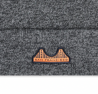 Close up detail shot of gray knit beanie with a San Francisco Golden Gate Bridge woven patch