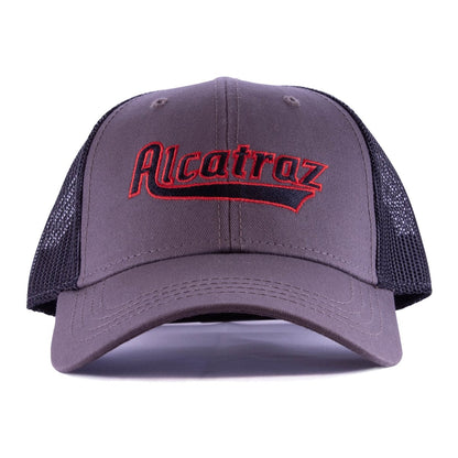 Grey and black mesh trucker cap with red and black embroidered Alcatraz logo on front panels.