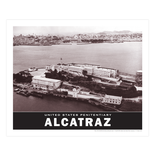 United States Penitentiary Alcatraz poster by the Golden Gate National Parks Conservancy, featuring a 1950s black and white aerial photograph of the island, with San Francisco in the background.